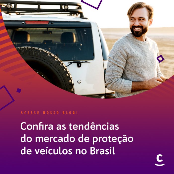 Um homem sorridente de barba e suéter ao lado de um carro de modelo jipe 4x4 na estrada, com um fundo vermelho e o roxo e a frase: Confira as tendências do mercado de proteção de veículos no Brasil